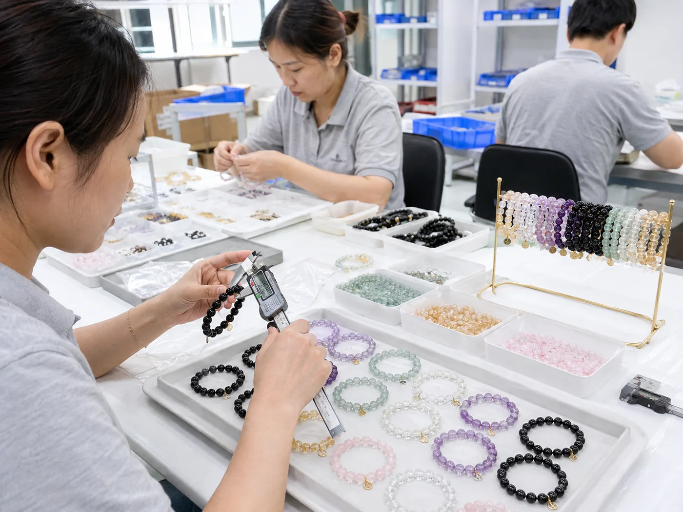 Crystal bracelet factory workers measuring bead size and inspecting finished bracelets